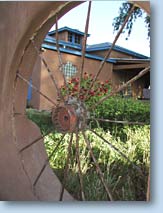 Photo of building and flowers through nearby wheel